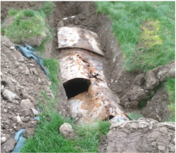 Partially collapsed and leaking steel septic tank